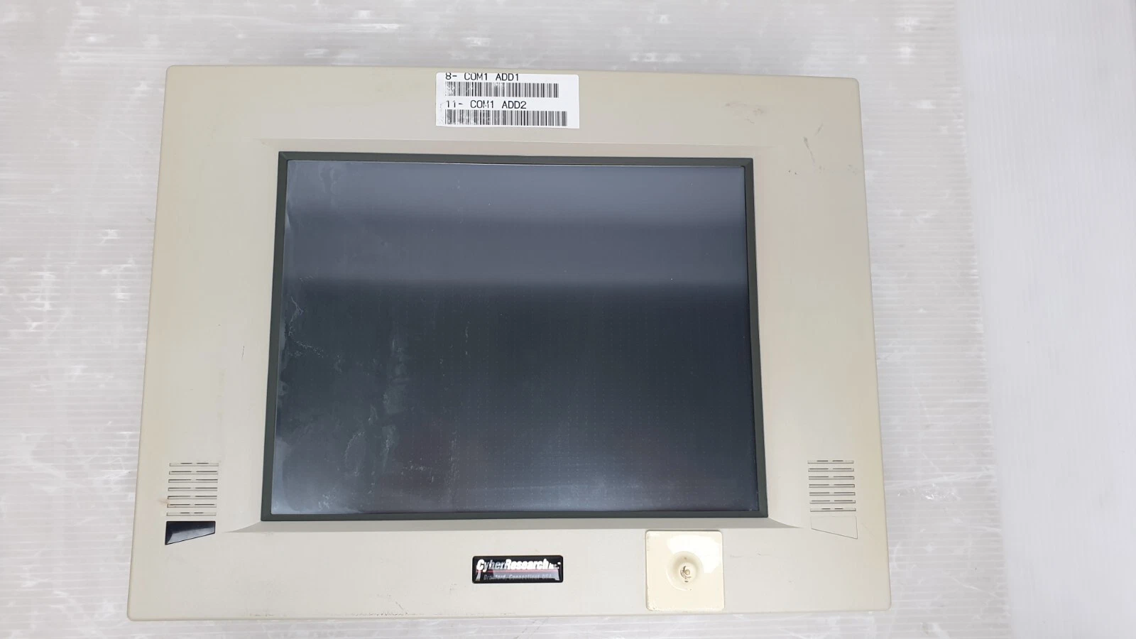 Front bezel of the STC 12-T with a COM1 ADD1 / COM1 ADD2 label above the display