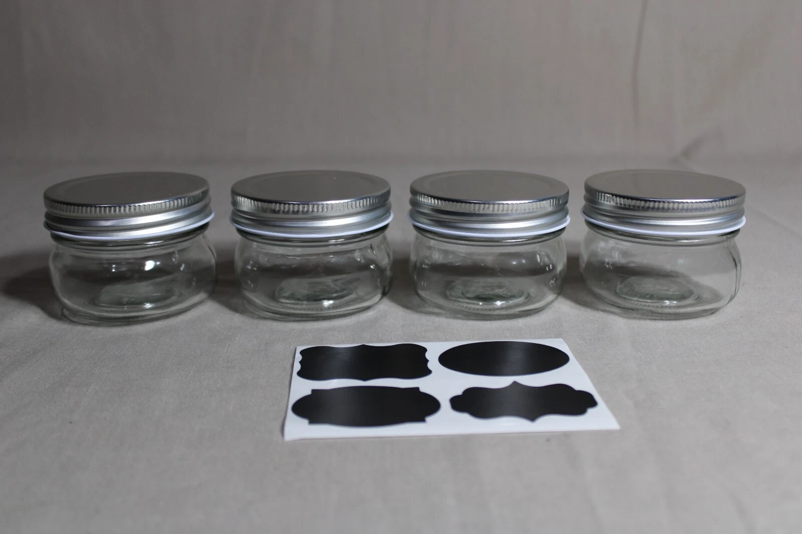 4 NEW FK CO 2" Tall Clear Glass 5 Oz Jars With Silver Lids