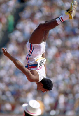 Daley Thompson of Great Britain does a back flip to celebrate his - Old Photo