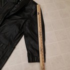 Black leather trench coat with wide shoulder pads, double-breasted buttons, and visible stitching, medium size.