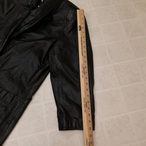 Black leather trench coat with wide shoulder pads, double-breasted buttons, and visible stitching, medium size.
