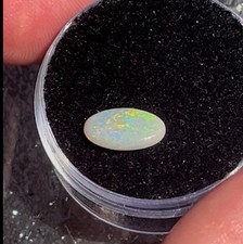 Australian dark opal cabochon, bright colors, greens blues reds, .5 carats