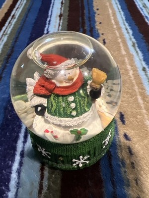 A contemporary Christmas snow globe featuring Santa Claus.