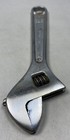 Silver 6-inch adjustable crescent wrench with worn handle, yellow “PROTO” logo, and metal jaw markings on a light background.