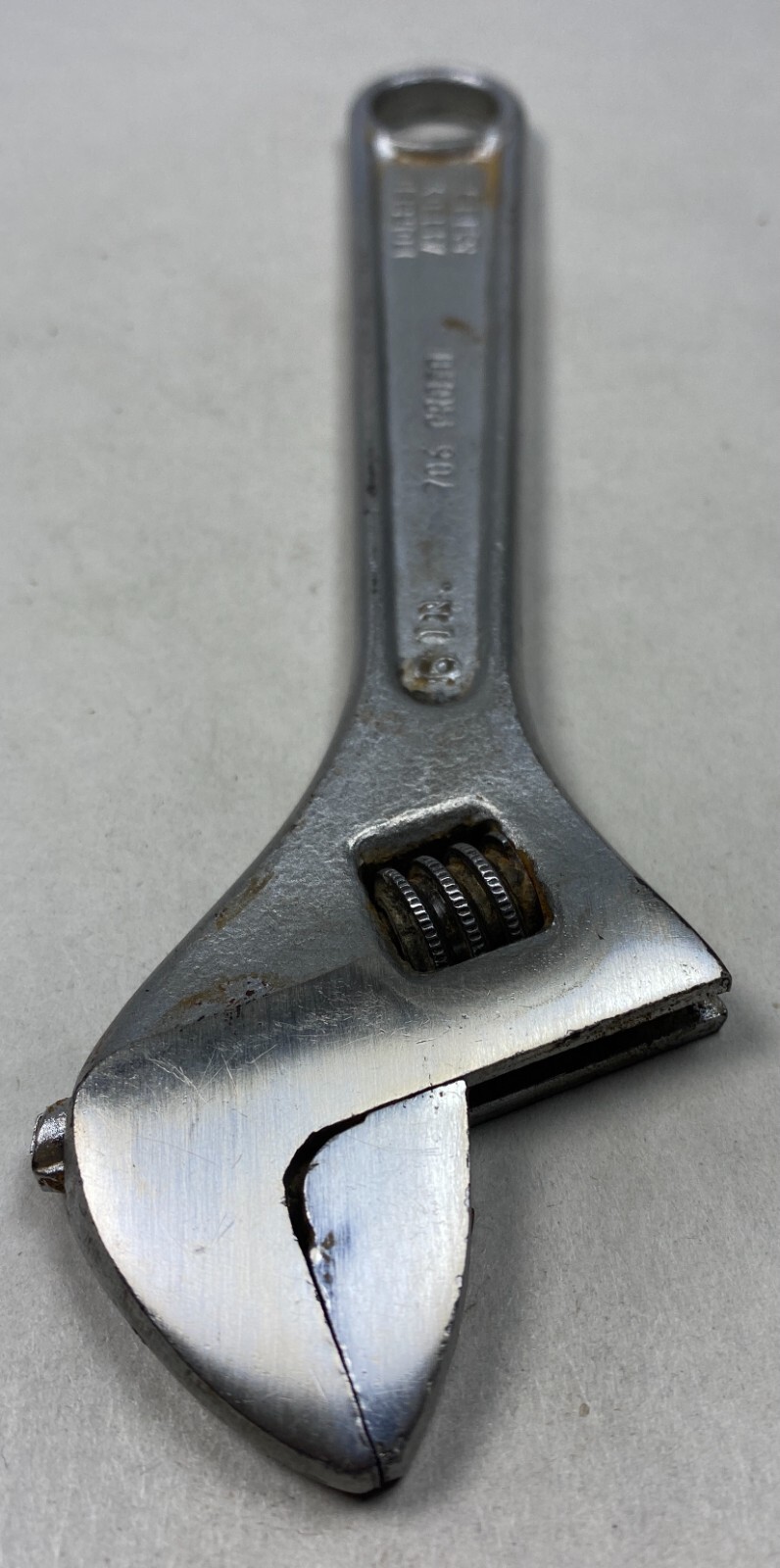 Silver 6-inch adjustable crescent wrench with worn handle, yellow “PROTO” logo, and metal jaw markings on a light background.