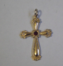 Gold tone ornate ruby red center stone religious cross pendant