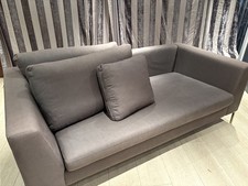 A grey 3 seat sofa from Anthropology in thick fabric.