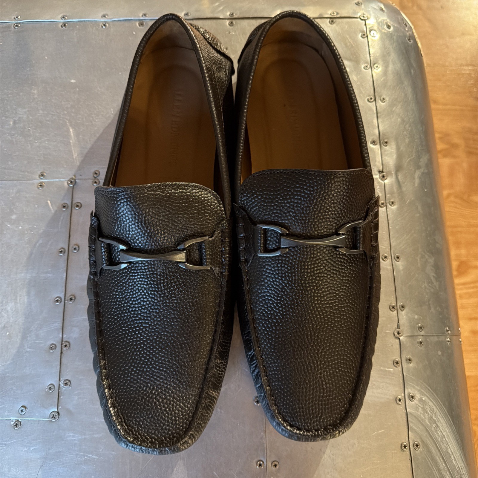 Dark brown textured Allen Edmonds men’s loafers with silver horseshoe-shaped brake handle and visible Made in USA branding.