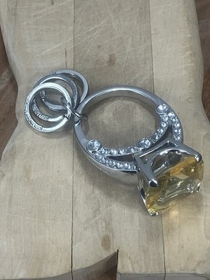 Keychain By  Juicy Couture featuring a yellow cushion-cut stone