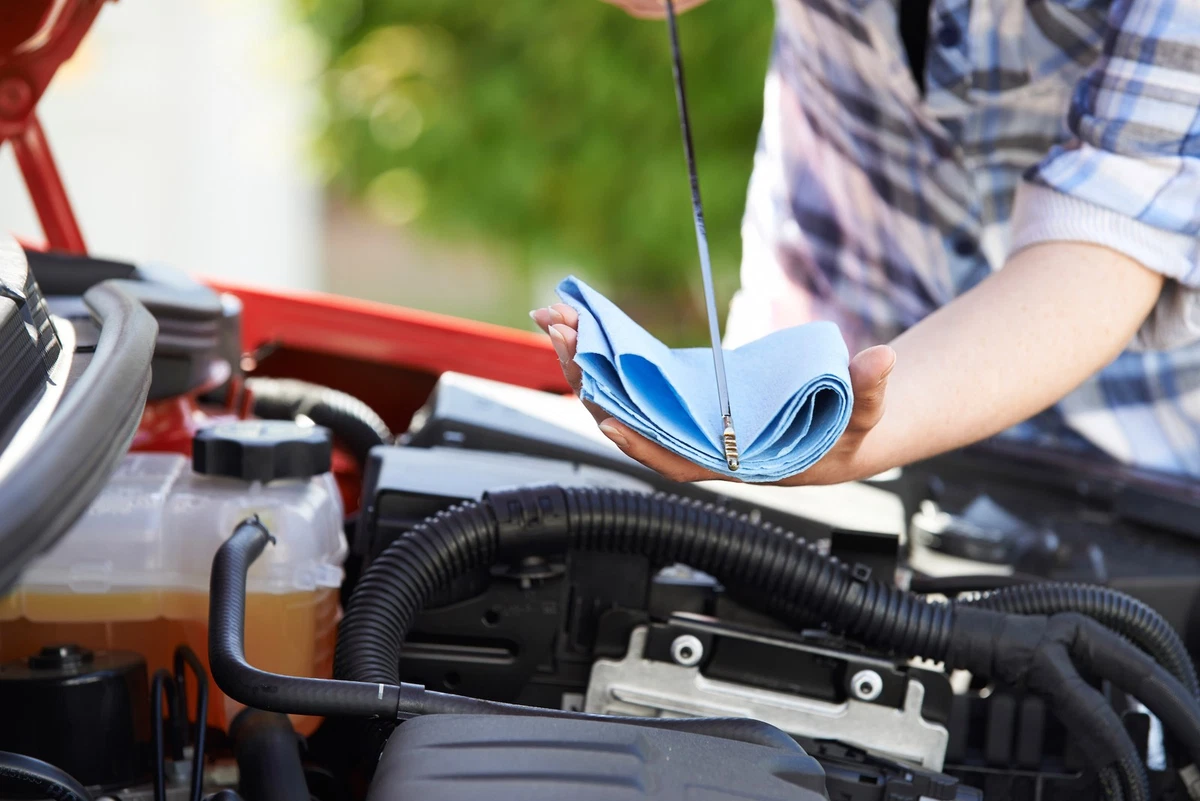 Checking car engine oil level on dipstick