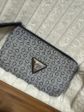 This Is A GUESS Monogram Wristlet Clutch Bag In A Black and Grey Color Scheme.
