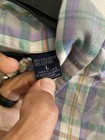 Men’s long-sleeve button-up shirt with purple, green, and yellow plaid pattern, 65% polyester 35% cotton label visible.