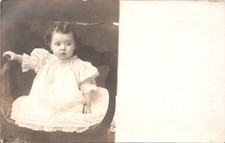 RPPC Baby in White Sitting On Chair Postcard XJ1