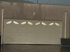 White Garage door with windows and a motor, rolls up. Is used but is very good