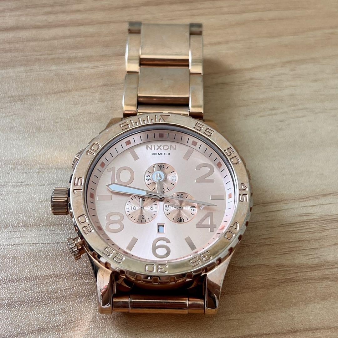 Nixon Pink Gold Chronograph Watch with Fixed Bezel
