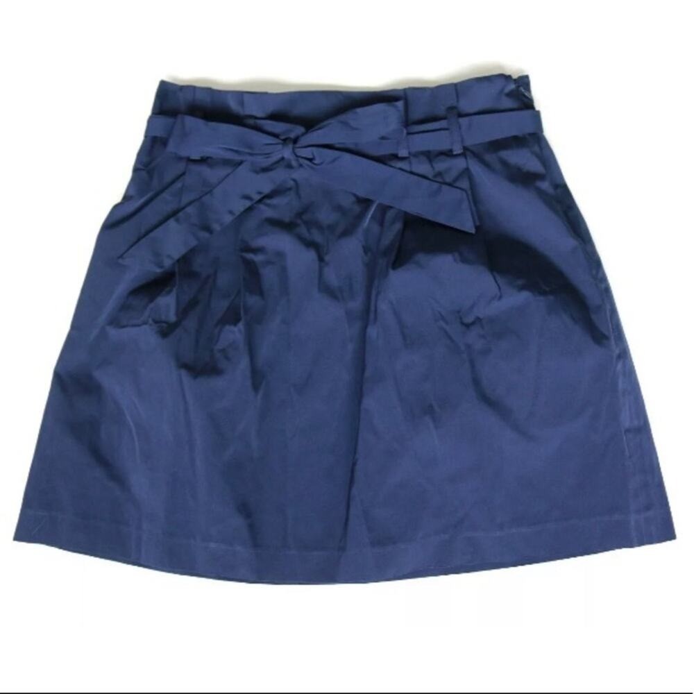 Navy blue paperbag waist skirt with matching fabric belt, side buckle detail, and “USA Made!” text on inner waistband.