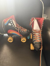 Moxi Black Quad Roller Skates with Rainbow Laces and Yellow Wheels