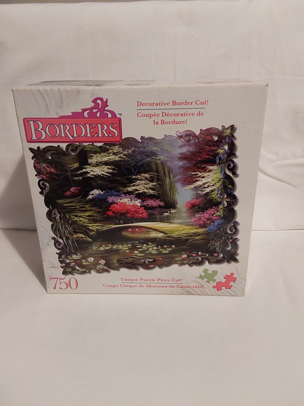 Dogwood Morning puzzle box with pink roses, green forest scene, and “750” text, made in USA.