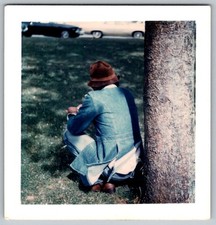 Vtg Color Snapshot Man In Denim Jacket And Brown Hat Crouching By Tree 1970s