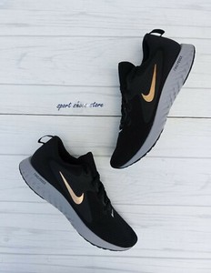 nike running legend react trainers in black and gold