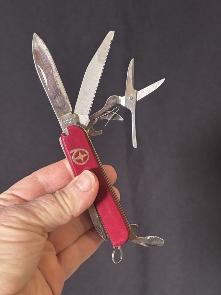 A chunky vintage Swiss Army-style multi-tool in eye-catching red — the kind of EDC piece that looks better with age and actually gets used.