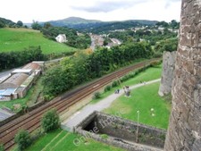 Photo 6x4 North Wales Railway spans the rock cut ditch around Conwy Castl c2009