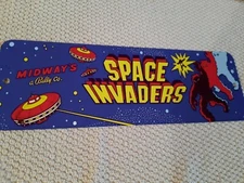 a Space Invaders Arcade Marquee 4x12 Metal Wall Sign