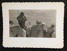 U.S. Navy Military Looking Over Ship Deck at Rescue Boat in Ocean Snapshot Photo