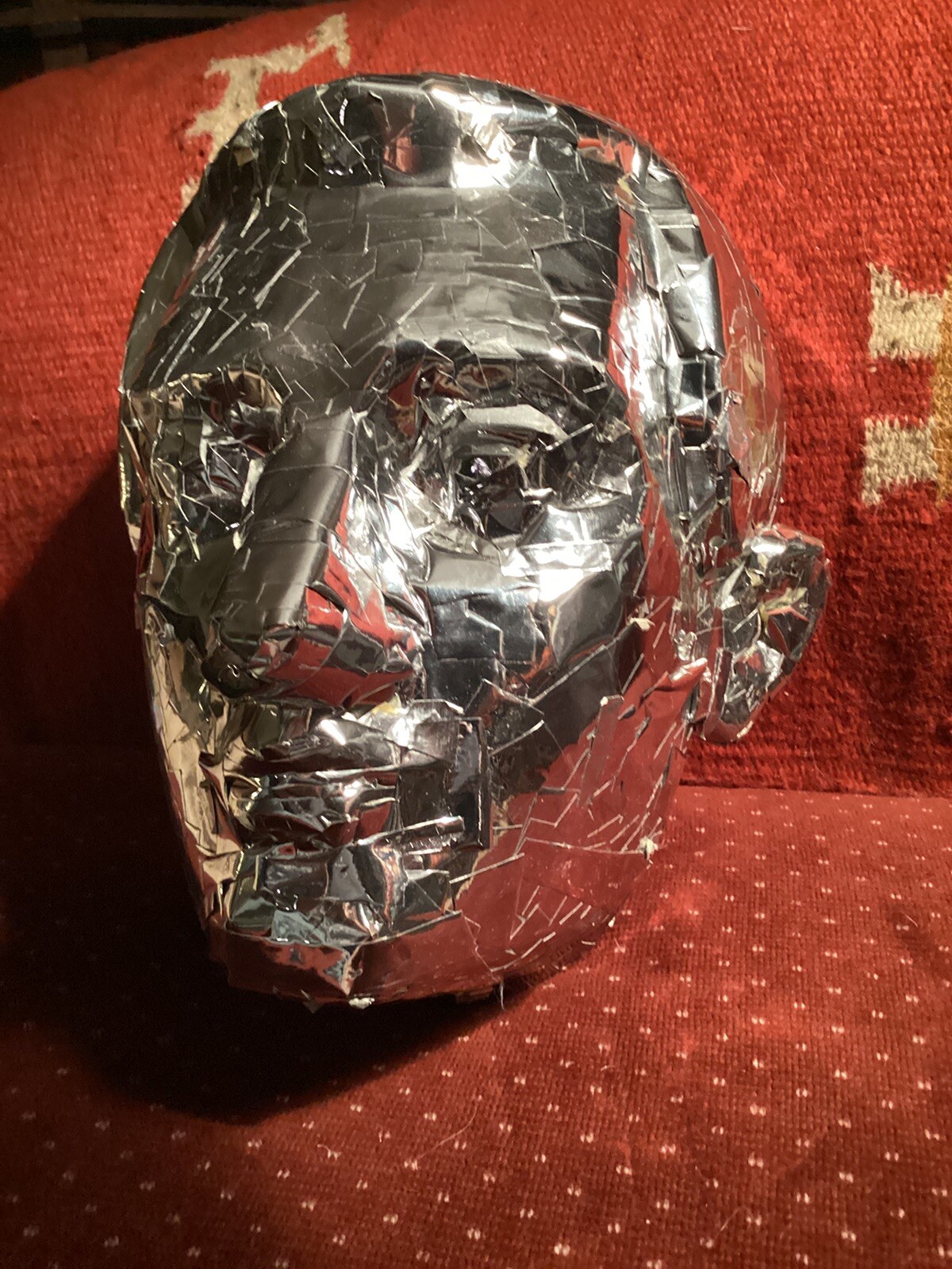 tinfoil covered man’s face mask, lifesized at 12” high x 10” wide x 10