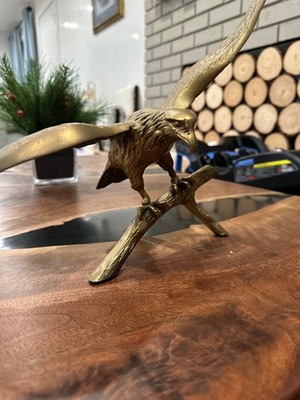 vintage brass eagle figurine or sculpture, often depicting a bald eagle perched
