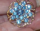 Vintage Ice Blue Rhinestone Atomic Goldtone Metal Pin Unsigned Costume Jewelry