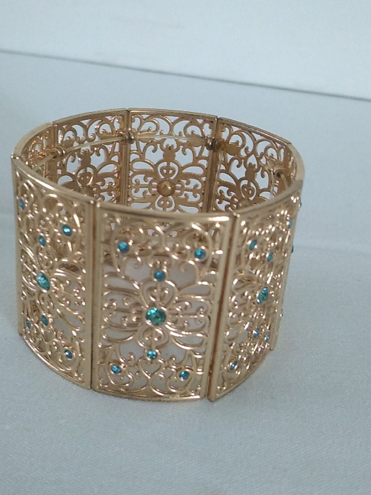Gold Tone Stretchy Boho Bracelet with Blue Rhinestones Open Work Design-image