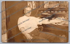 Antique RPPC young man sitting at desk shirt sleeves rolled Real Photo Postcard 