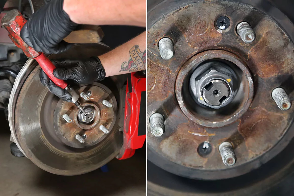 A mechanic uses a punch to peen the axle nut ring.
