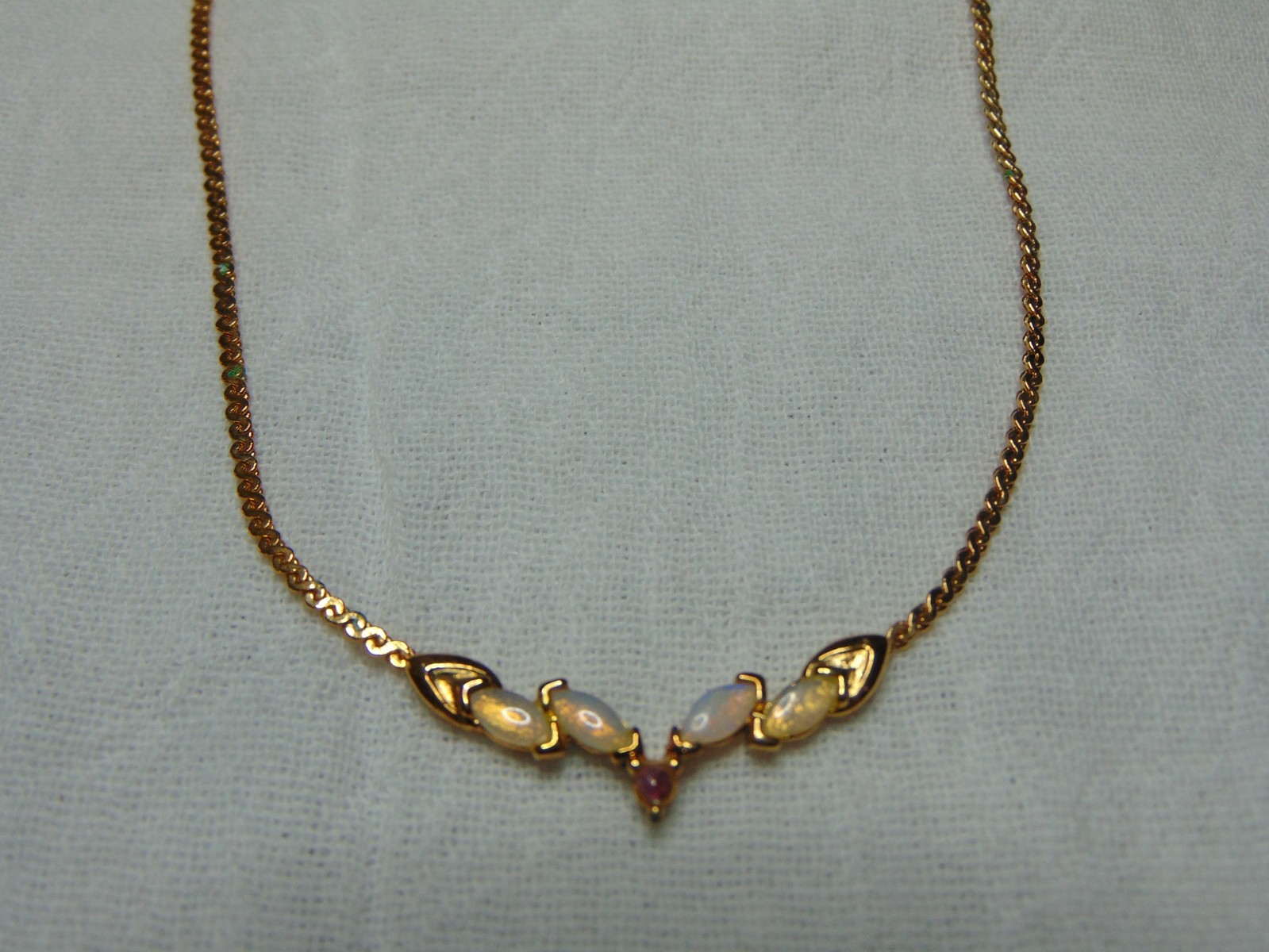 vintage delicate necklace with opals and tiny garnet stone