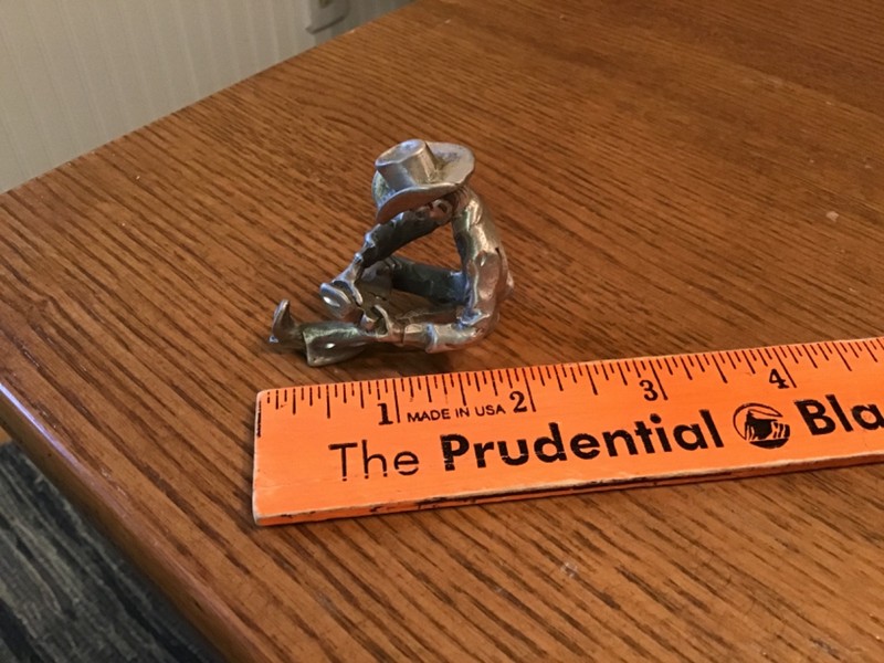 Miniature Pewter Cowboy in Sitting Position Removing His Boots