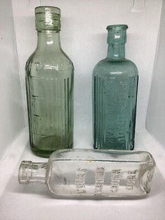 MEDICINE / POISION BOTTLES x 5 IN ICE BLUE/AQUA/BROWN & CLEAR EMBOSED AS DUG