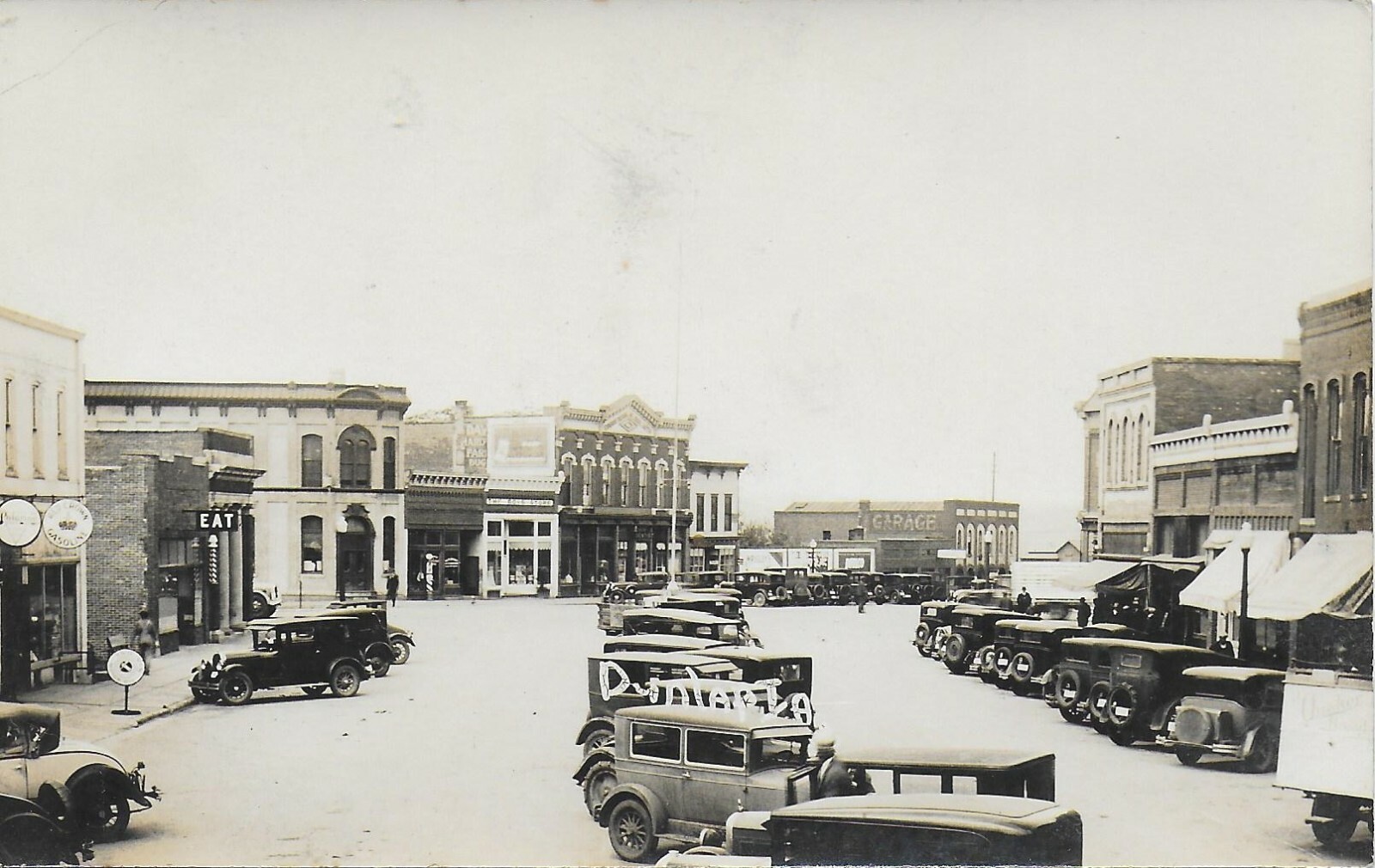 2 RPPCs Street Scenes in Dunlap Iowa 192030s w/ Autos and Businesses