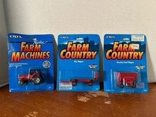 ERTL LOT OF 3- # 458 CASE 7110 TRACTOR, #465 HAY WAGON, #1864 GRAVITY FEED WAGON