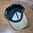 Green vintage Dairyland seed hat with tan brim, dark green interior, and visible K-Products USA Made label.