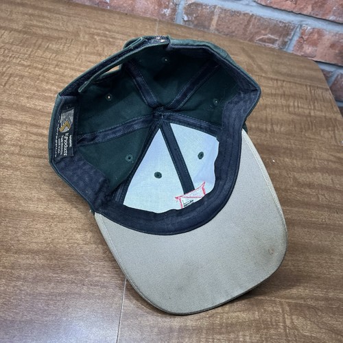 Green vintage Dairyland seed hat with tan brim, dark green interior, and visible K-Products USA Made label.
