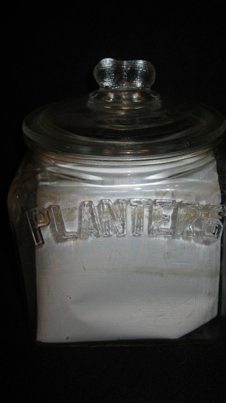 1934 PLANTERS ORIGINAL SQUARE JAR WITH ORIGINAL GLASS PEANUT LID