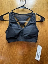 Women NWT "Kyodan" black and magenta sports bra with pads. Size XS.