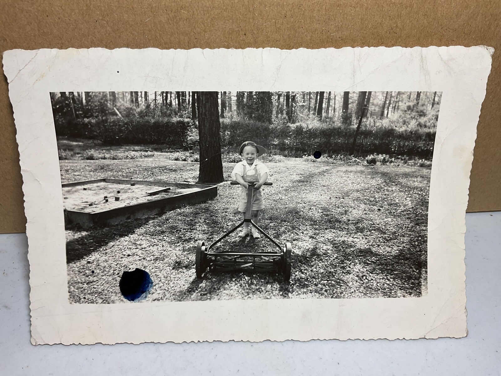 25 Mar 1945 Photograph Young Boy Pushing Lawn Mower Hat Sandbox S1324