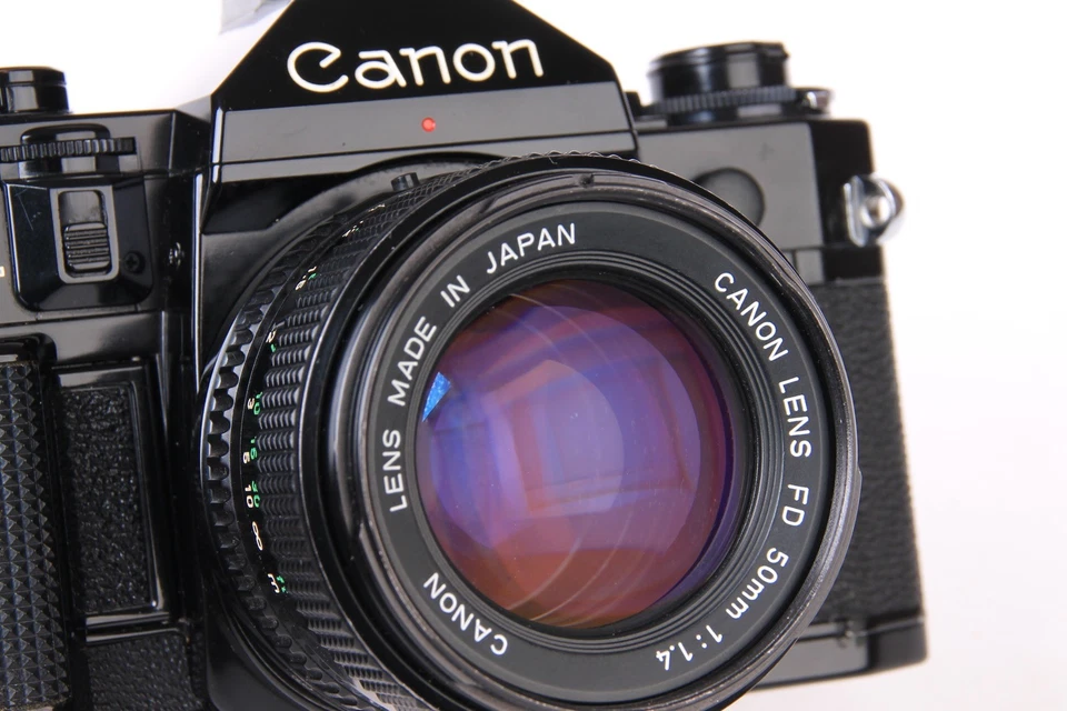 Cuerpo de cámara Canon A-1 SLR negro con lente 50 mm f1,4 FD y bobinadora eléctrica Jessop C-1TR Foto 3 de 4