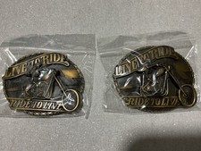A pair of Live To Ride Ride To Live Motorcycle Belt Buckle