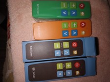 Two EZ Clicker Big Button Universal TV Remotes. One is Orange and Other Is Green