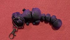 Purple articulated 3D printed cat keychain movable joints, shiny iridescent.