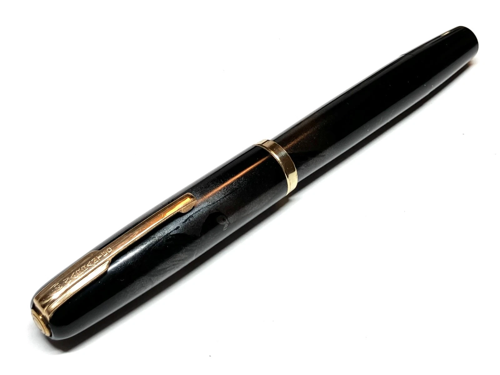 Black vintage fountain pen with gold nib, urushi maki-e body, and “HARUYAMA made” text on barrel.