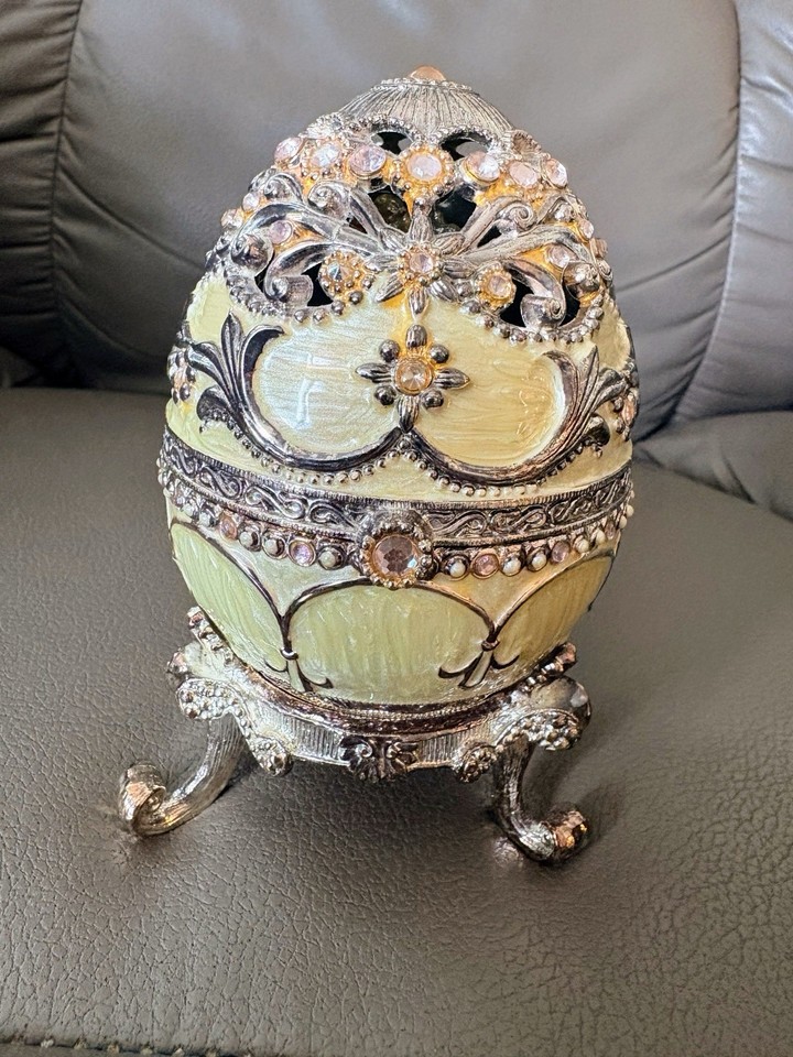 A jeweled, rhinestone-adorned enamel egg music box in the Fabergé style — over-the-top glamorous in the best possible way.